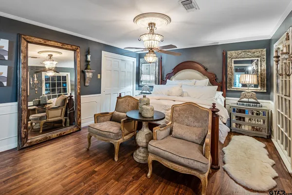 a living room with furniture a fireplace and wooden floor