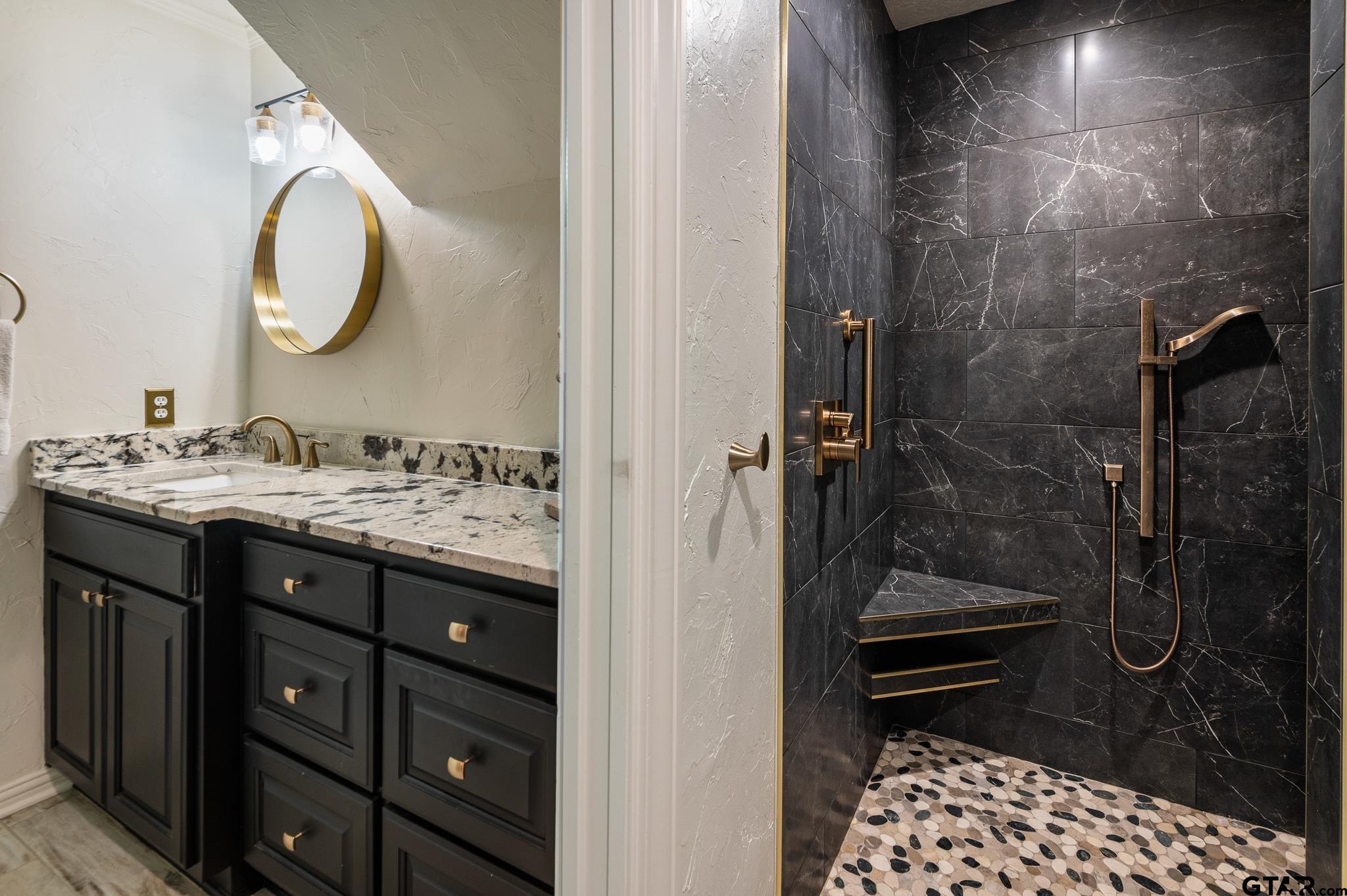 668 County Road 108 Carthage, TX 75633 - Photo 30 of 42 a bathroom with a sink a mirror and a shower