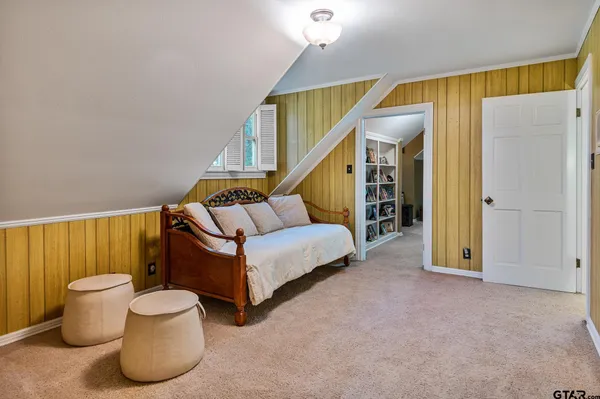 a living room with furniture and a ceiling fan