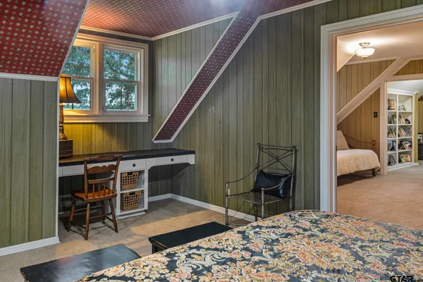 a bedroom with furniture and a window