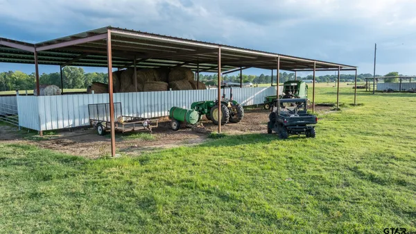 a view of a chair and table in backyard of house