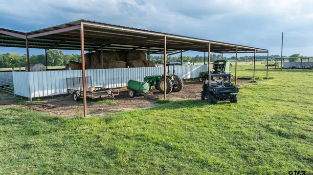 a view of a chair and table in backyard of house