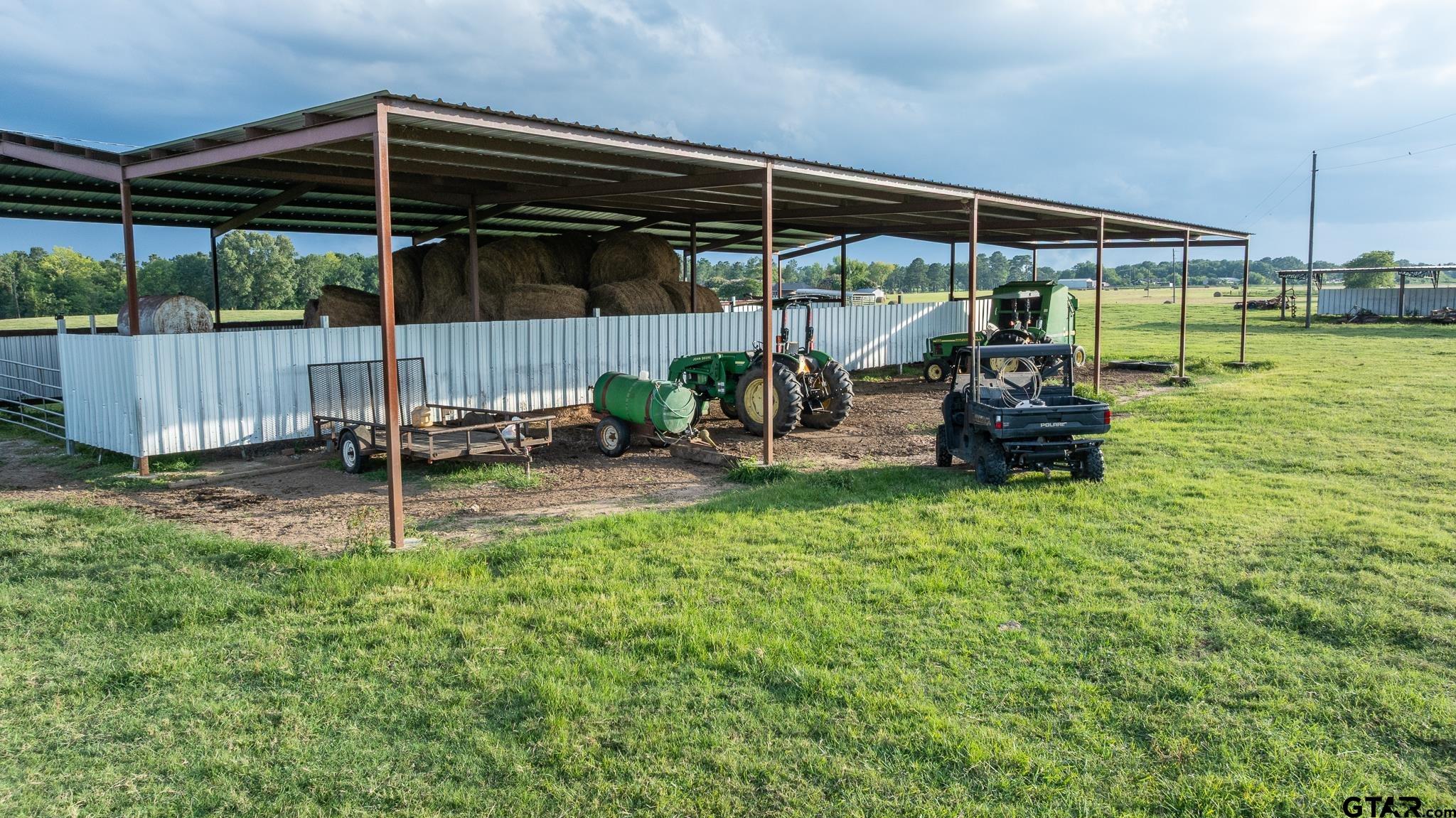 668 County Road 108 Carthage, TX 75633 - Photo 36 of 42 a view of a chair and table in backyard of house