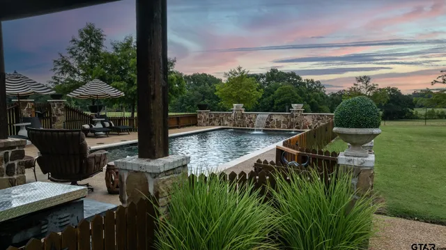 a view of a swimming pool with a patio