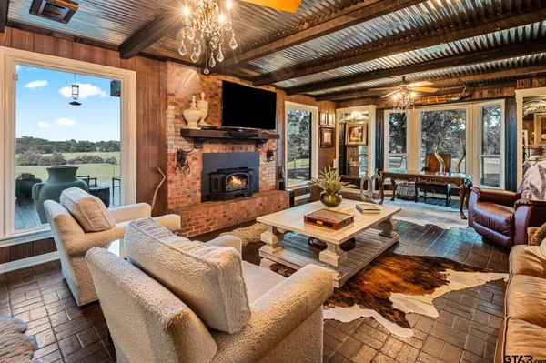 a living room with furniture a flat screen tv and a fireplace