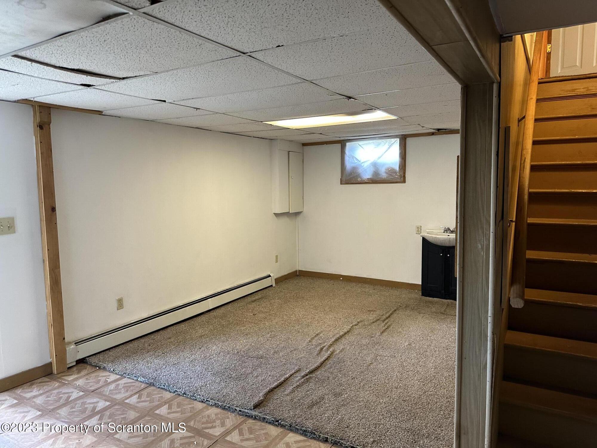 514 Morse Avenue Simpson, PA 18407 - Photo 4 of 9 a view of a hallway with wooden floor and stairs