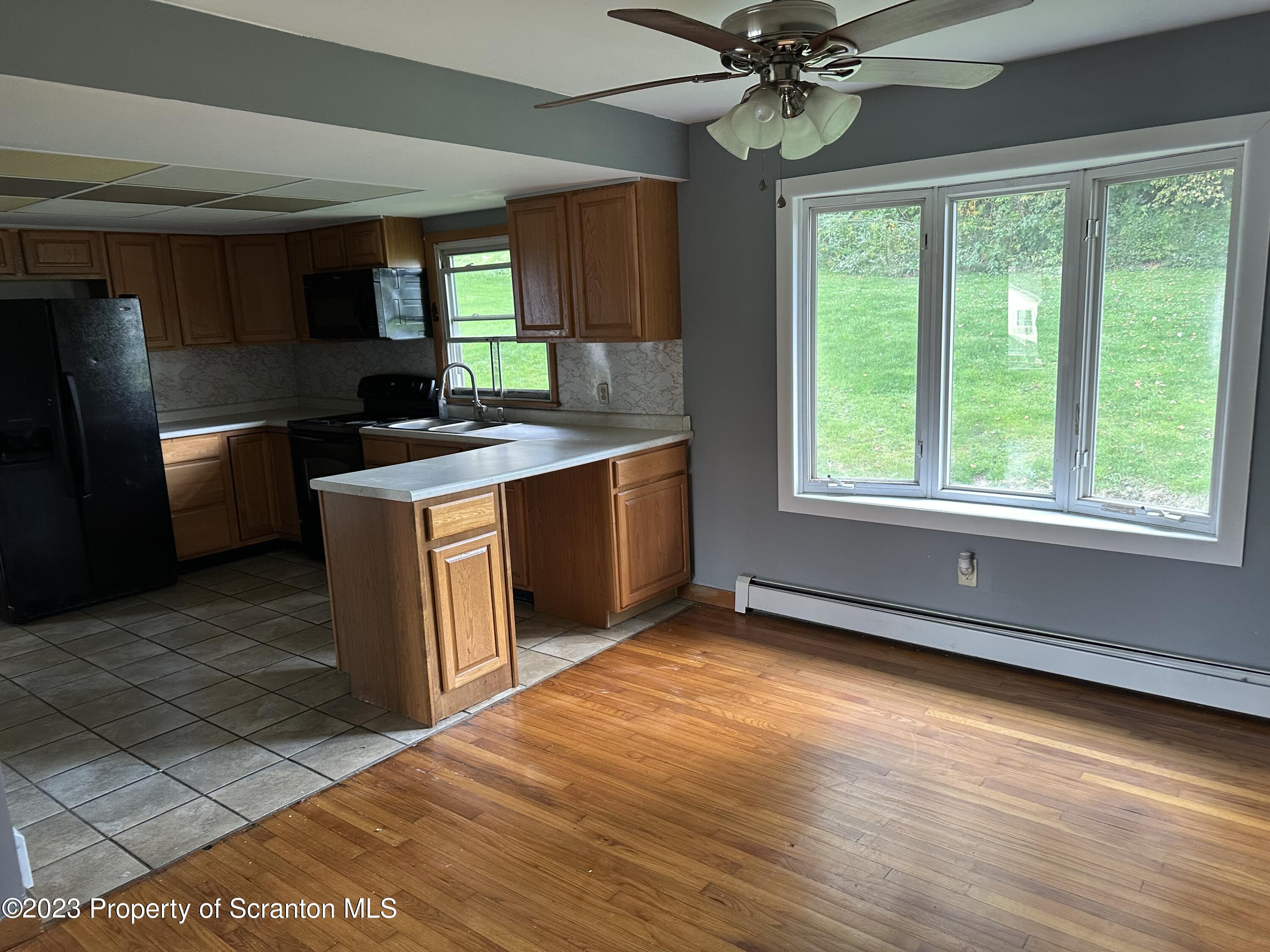 514 Morse Avenue Simpson, PA 18407 - Photo 9 of 9 a kitchen with stainless steel appliances granite countertop a stove a sink and a refrigerator