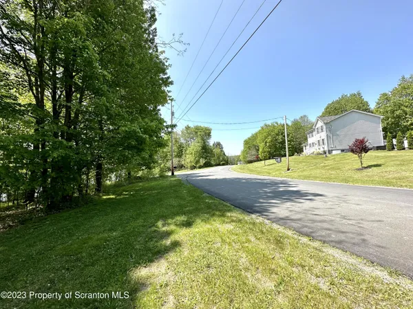 a view of a house with a backyard and a tree