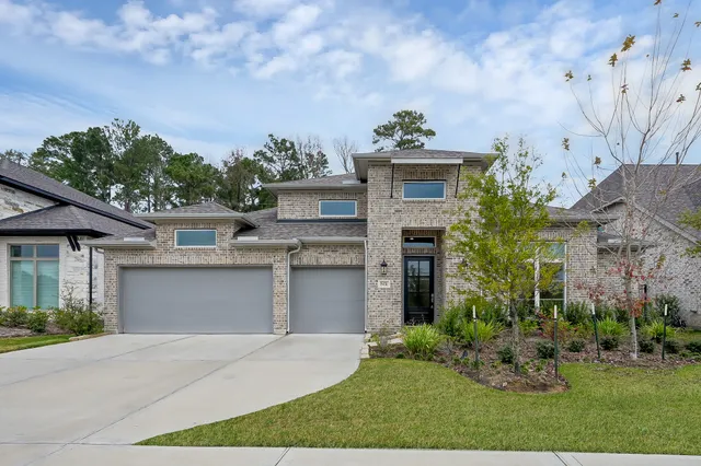 a front view of a house with a yard and a garage