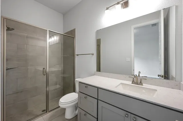 a bathroom with a sink toilet and shower