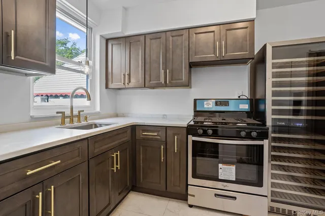 a kitchen with cabinets appliances and a window