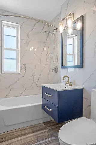 a bathroom with a sink a toilet and bathtub