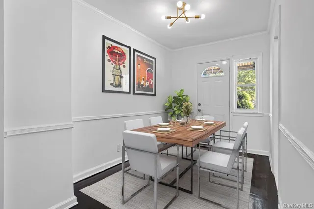 a view of a dining room with furniture and chandelier