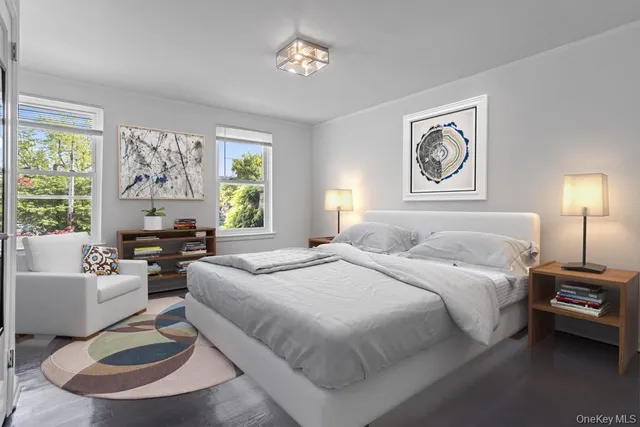 a spacious bedroom with a bed a couch and a window