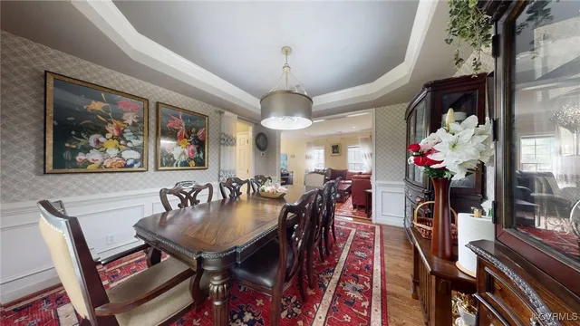 a view of a dining room with furniture wooden floor and a chandelier