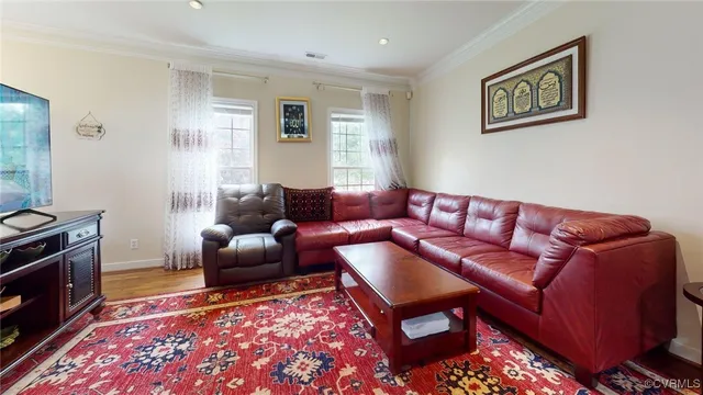 a living room with furniture and a rug