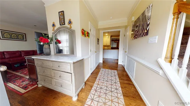 a view of hallway with mirror and furniture