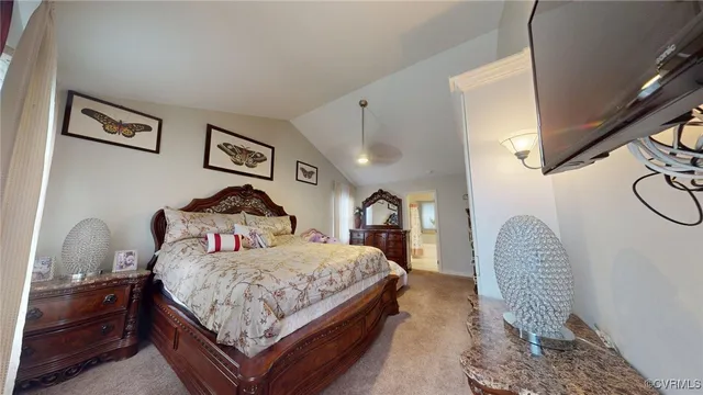 a bedroom with a bed and dresser with wooden floor