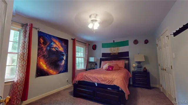 a bedroom with a bed and a painting on the wall