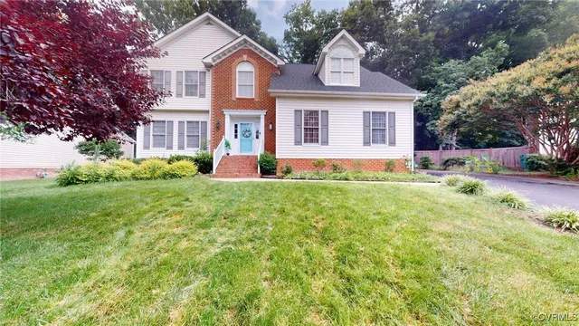 a front view of a house with garden and porch