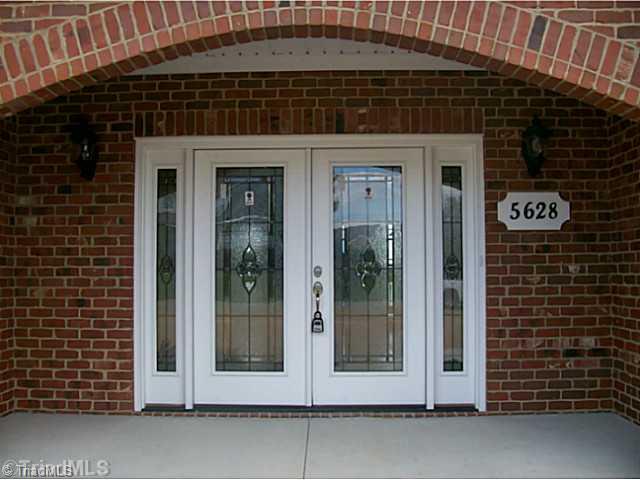 5628 Cape Fox Drive Oak Ridge, NC 27310 - Photo 3 of 16 Entry. Beautiful leaded glass double doors make for a grand entrance in a covered porch.