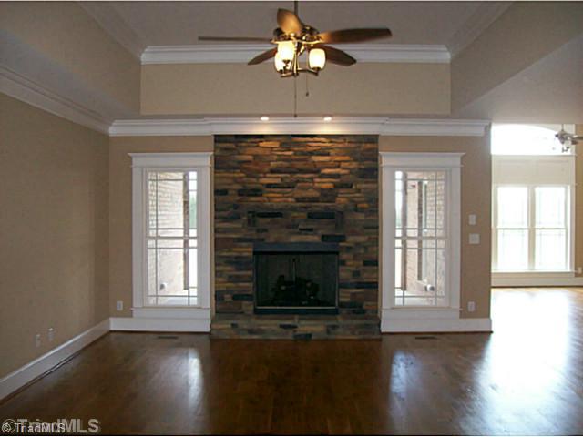 5628 Cape Fox Drive Oak Ridge, NC 27310 - Photo 4 of 16 Den/Family/Great Room. Open den with gas fireplace and rock profile.