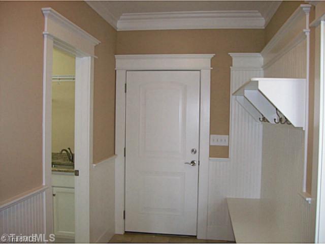 5628 Cape Fox Drive Oak Ridge, NC 27310 - Photo 8 of 16 Entry. Back entry opens onto tile with drop zone. Next to full size laundry room, powder room and opens to kitchen