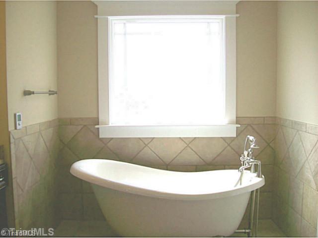 5628 Cape Fox Drive Oak Ridge, NC 27310 - Photo 10 of 16 Master Bath/Spa. Spacious master bath includes slipper clawfoot tub and private water closet.