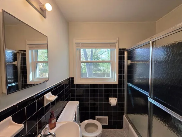 a bathroom with a toilet a sink and window