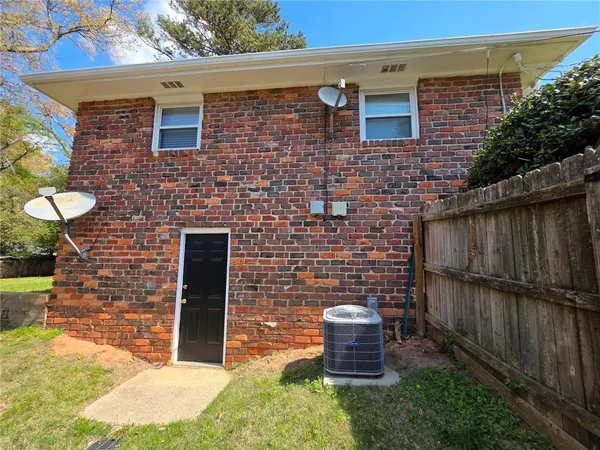 a brick building with a bench in front of it