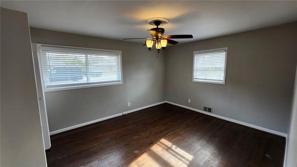 652 Forest Ridge Drive Southeast Marietta, GA 30067 - Photo 4 of 12 a view of empty room with wooden floor and fan