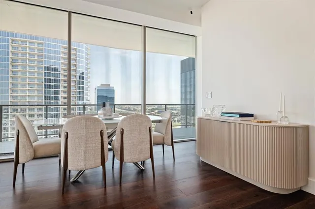a dining room with furniture and wooden floor