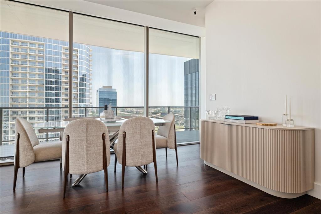 7901 Windrose Avenue, Unit 1701 Plano, TX 75024 - Photo 13 of 40 a dining room with furniture and wooden floor