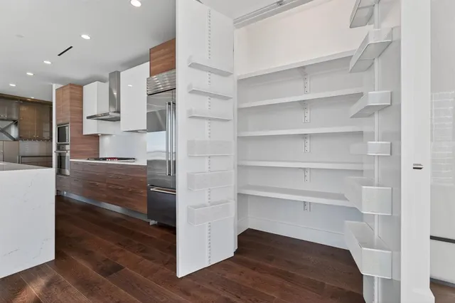 a view of a kitchen with cabinets and wooden floor