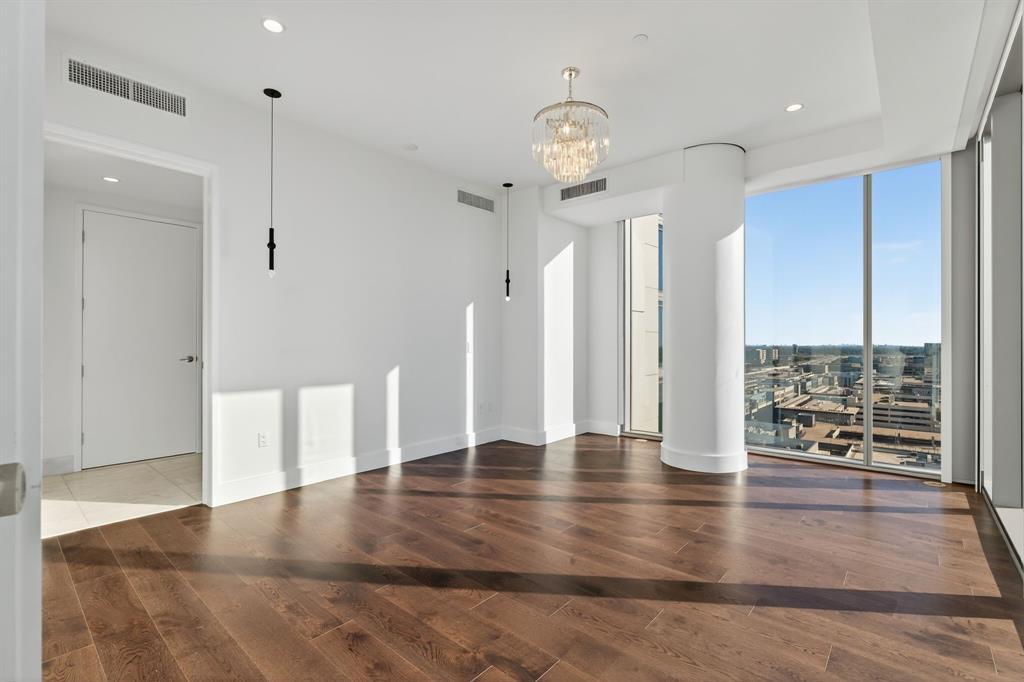 7901 Windrose Avenue, Unit 1701 Plano, TX 75024 - Photo 21 of 40 an empty room with wooden floor and outdoor view