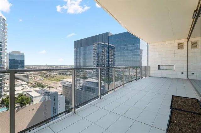 a lobby with furniture and lots of glass door