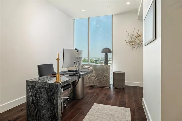a view of a workspace with furniture and wooden floor