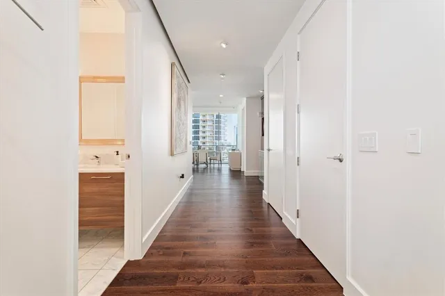 a view of a hallway with white doors