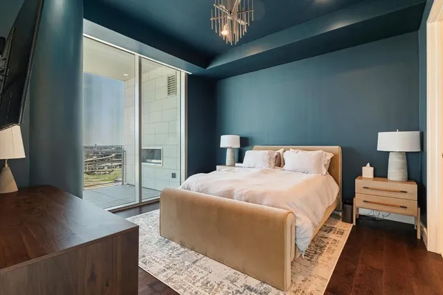 a bedroom with a bed and a chandelier