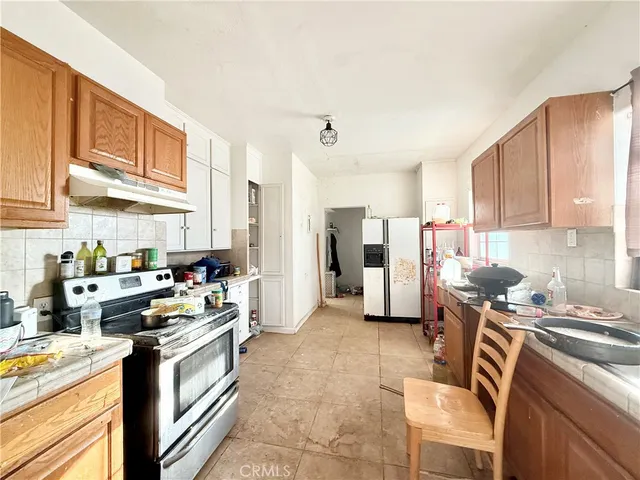 a living room with furniture a window and gym equipment