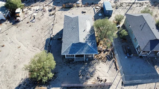 a backyard of a house with barbeque oven table and chairs