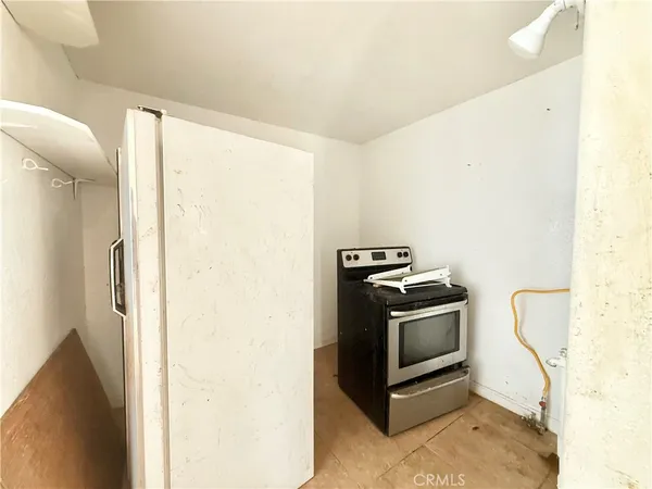 a kitchen with a stove and a refrigerator
