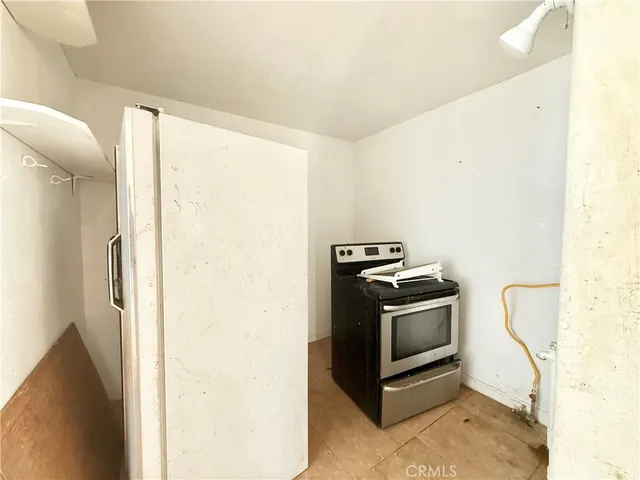 a kitchen with a stove and a refrigerator