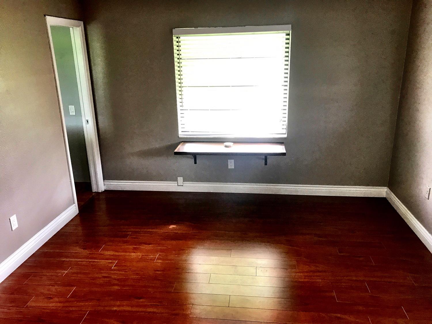 22250 Garrison Street Boca Raton, FL 33428 - Photo 18 of 26 a view of a room with wooden floors and a window