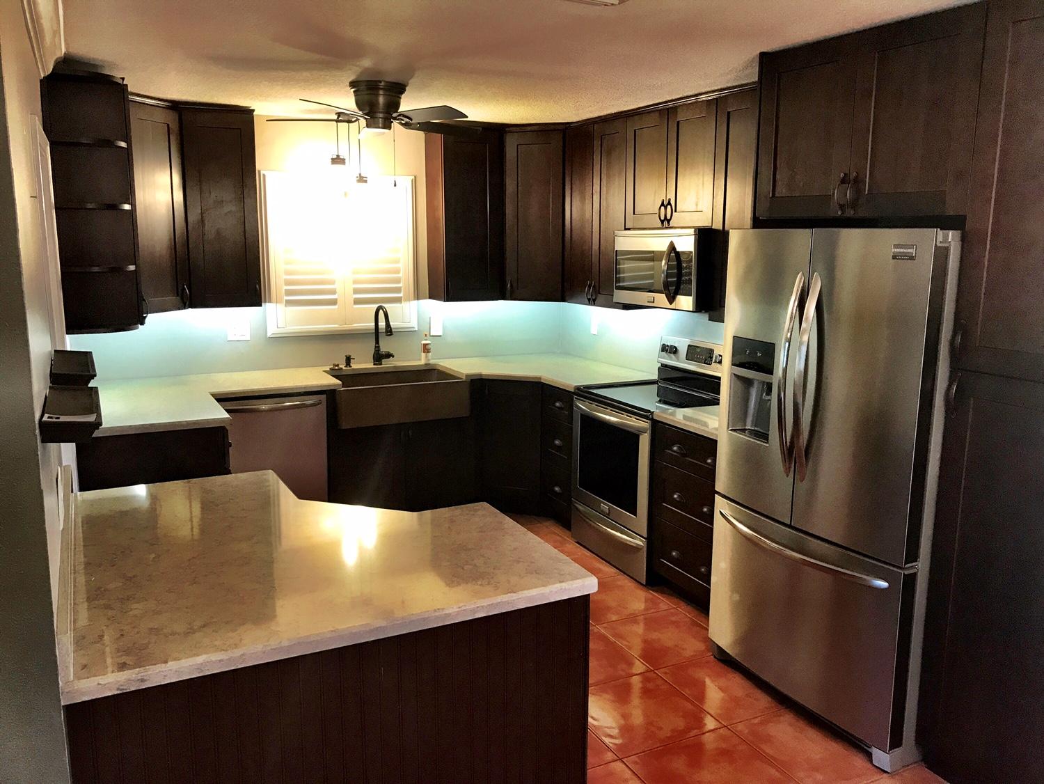 22250 Garrison Street Boca Raton, FL 33428 - Photo 24 of 26 a kitchen with stainless steel appliances a refrigerator a sink dishwasher and wooden cabinets with wooden floor
