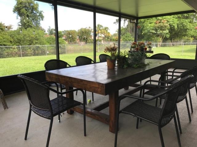 22250 Garrison Street Boca Raton, FL 33428 - Photo 3 of 26 a view of a chairs and table in patio next to a yard