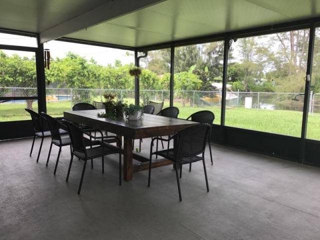 22250 Garrison Street Boca Raton, FL 33428 - Photo 4 of 26 a view of a dining room with furniture window and outside view
