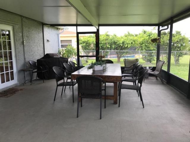 22250 Garrison Street Boca Raton, FL 33428 - Photo 5 of 26 a dining room with furniture and a floor to ceiling window