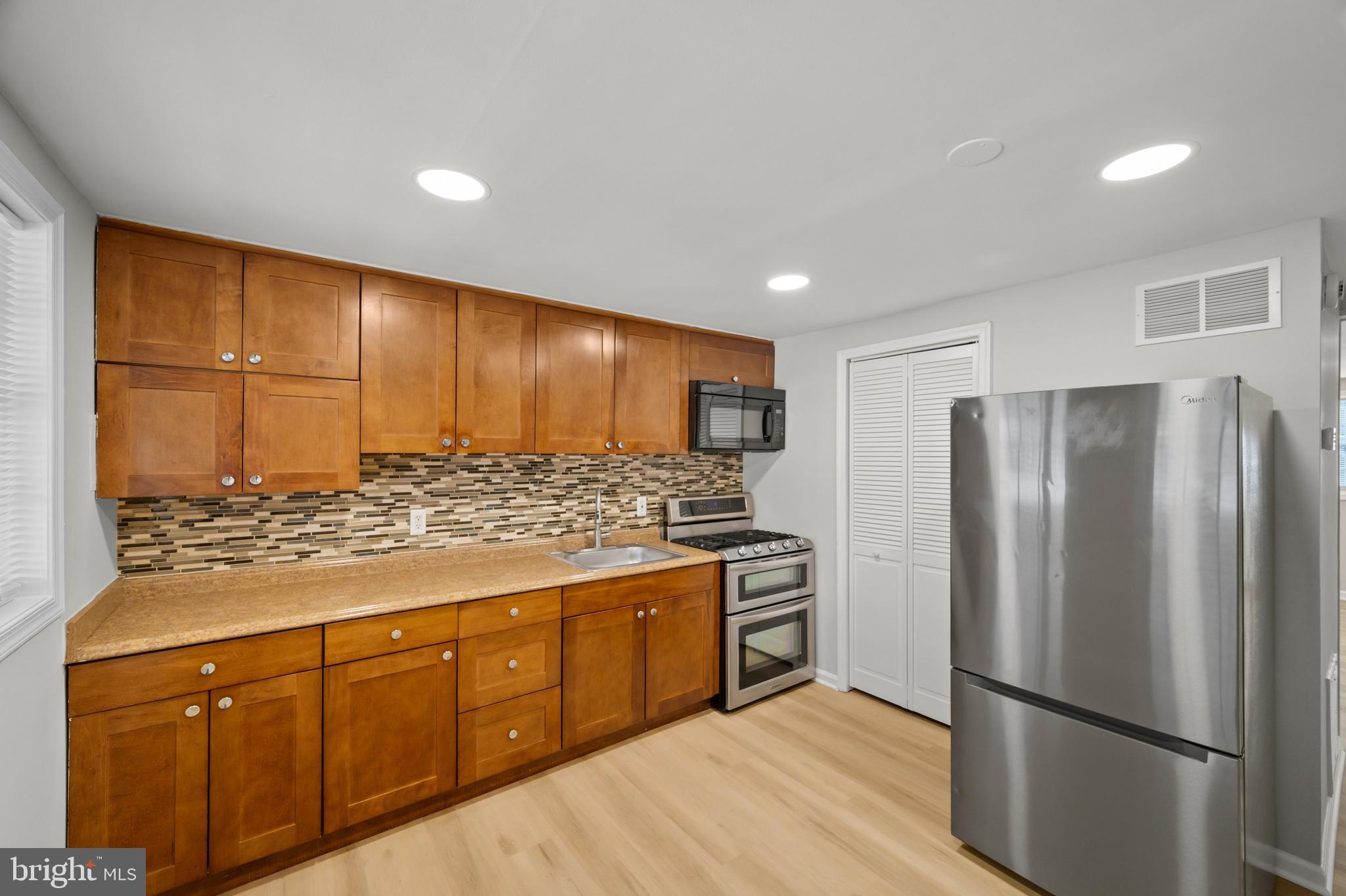817 5th Baltimore, MD 21227 - Photo 12 of 29 a kitchen with stainless steel appliances granite countertop a refrigerator and a stove top oven