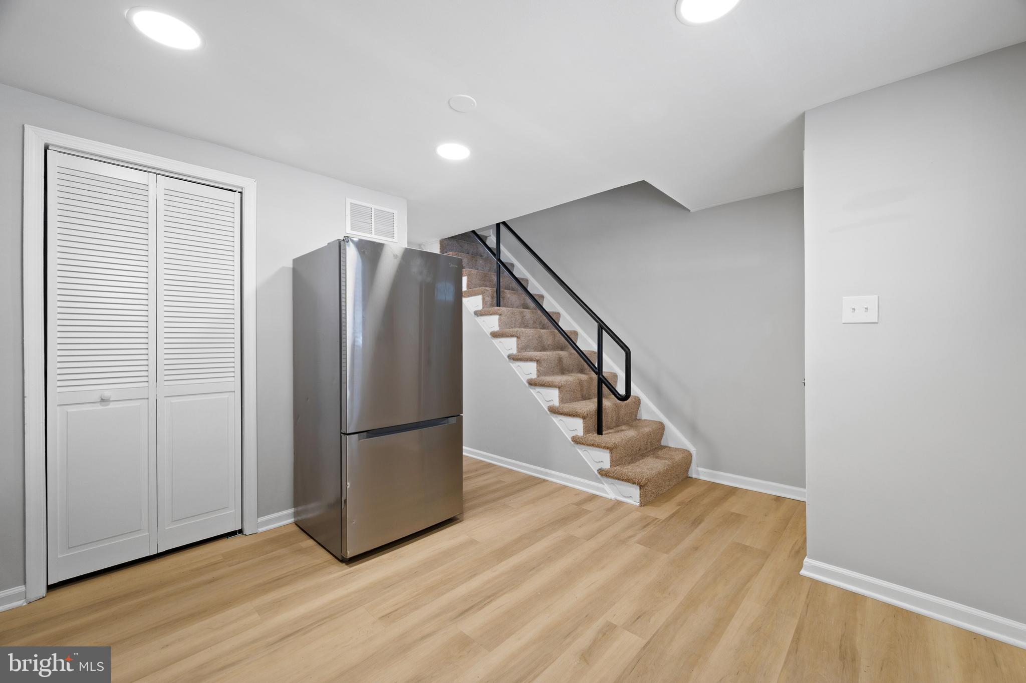 817 5th Baltimore, MD 21227 - Photo 13 of 29 a view of an empty room with wooden floor and stairs